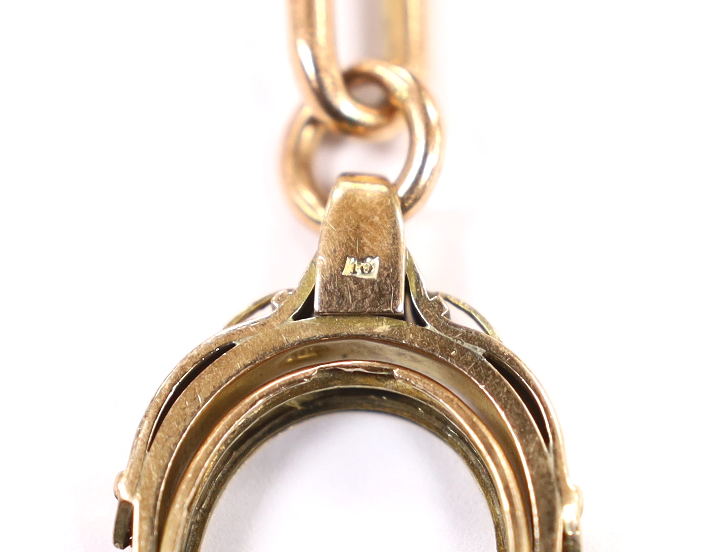 An early 20th century 9ct gold albert, hung with a damaged yellow metal spinning fob, length 43cm